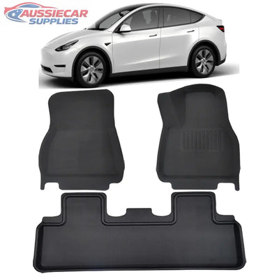 Black car floor mats with a white Tesla Model Y in the background